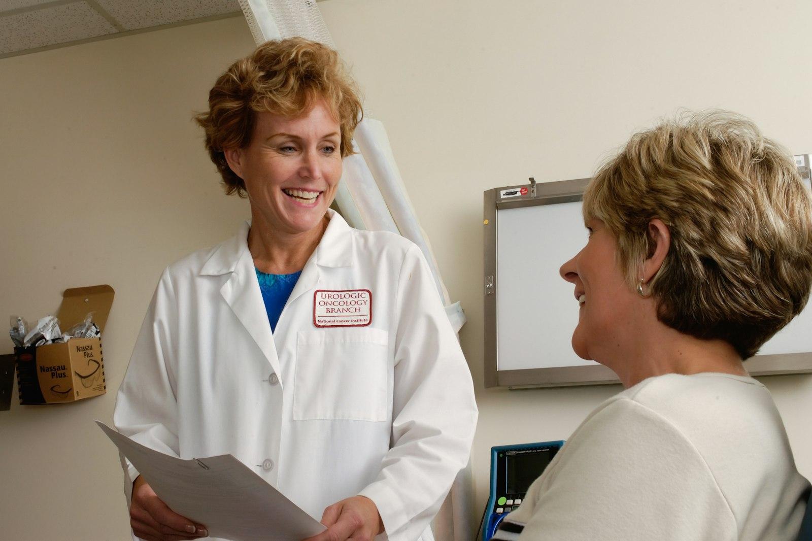 Senior compliance director reviewing customized safety binders with a practice manager in Healthcare Practices & Covered Entities